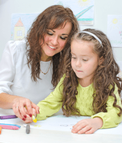 teacher teaching the girl on how to draw